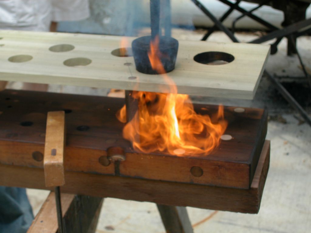 Chris Bono burning open the holes in the new racks for the pipe feet